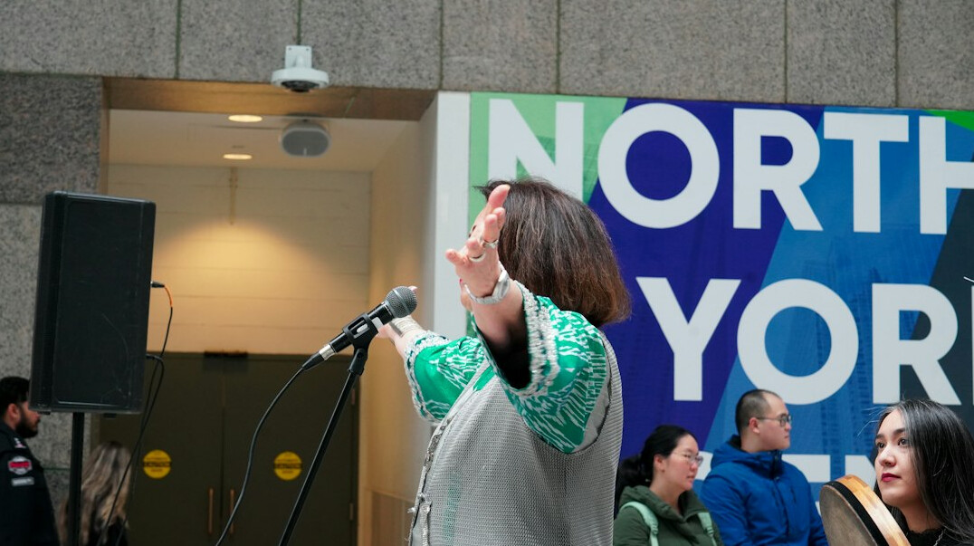 woman speaking confidently in front of audience