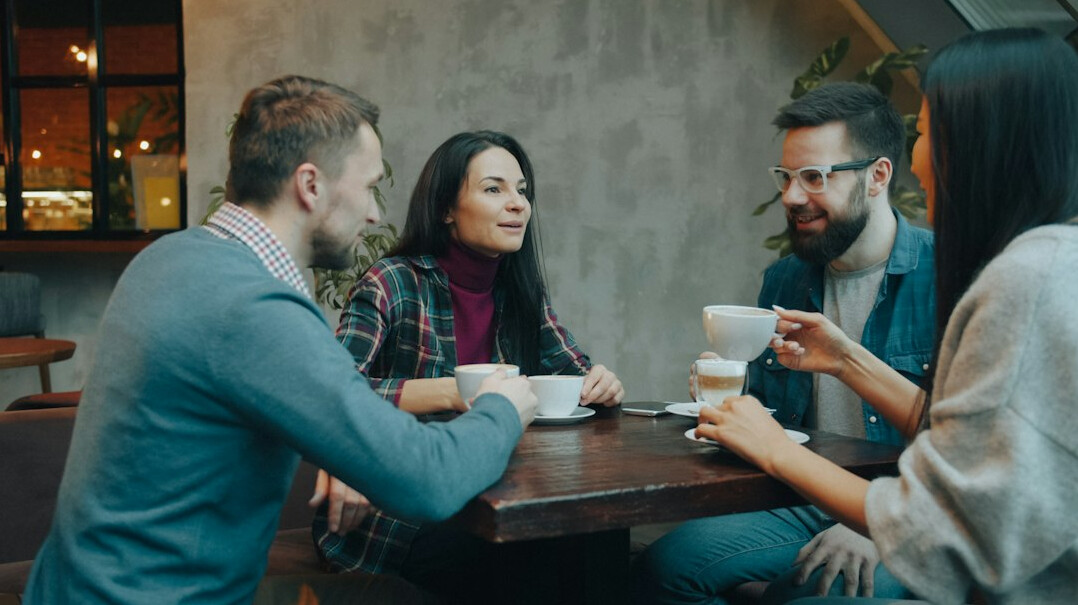 people having conversation in cafe