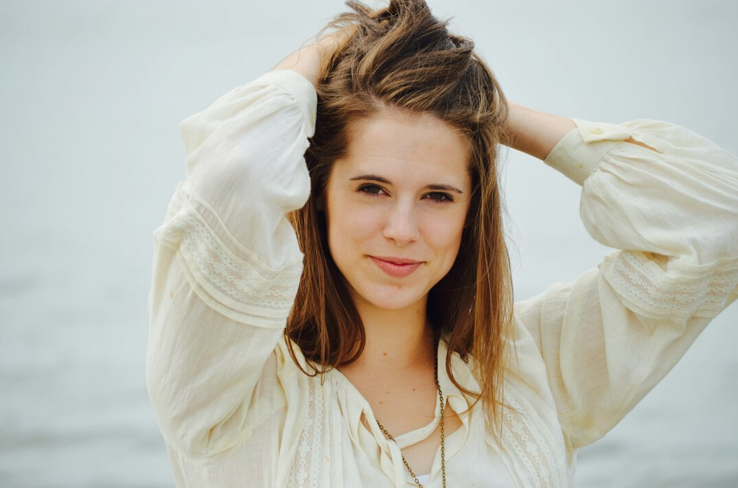 Portrait of a young smiling woman with light-brown hair