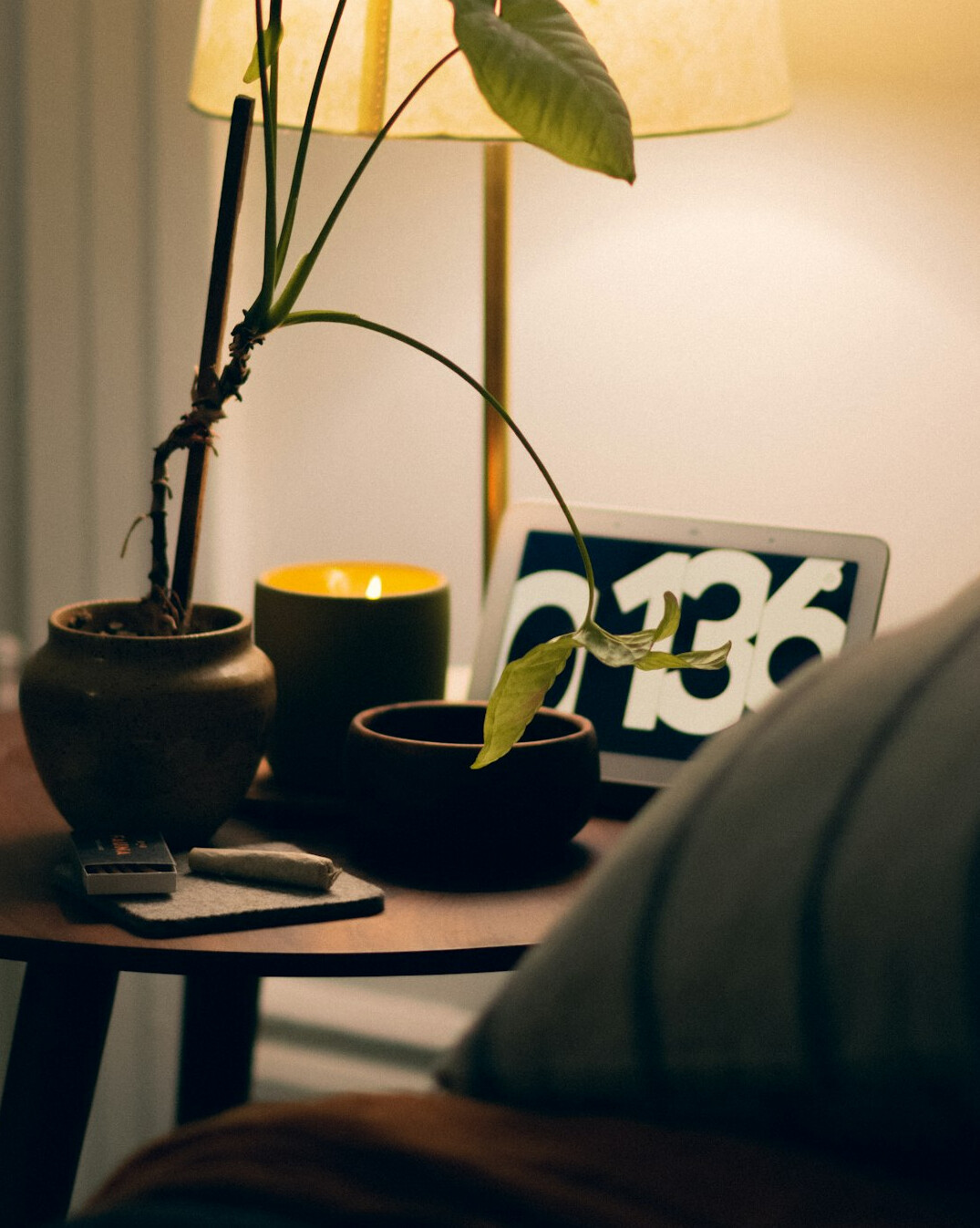 Laptop, open notebook and coffee cup on a wooden desk near a window